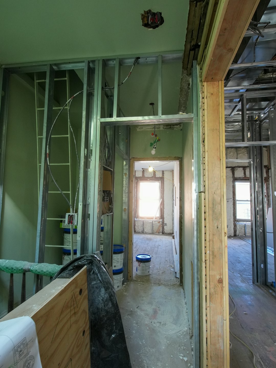 Construction materials sit inside a house undergoing renovation.